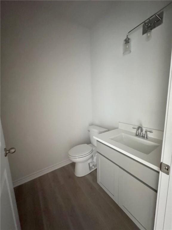 bathroom featuring vanity, hardwood / wood-style floors, and toilet