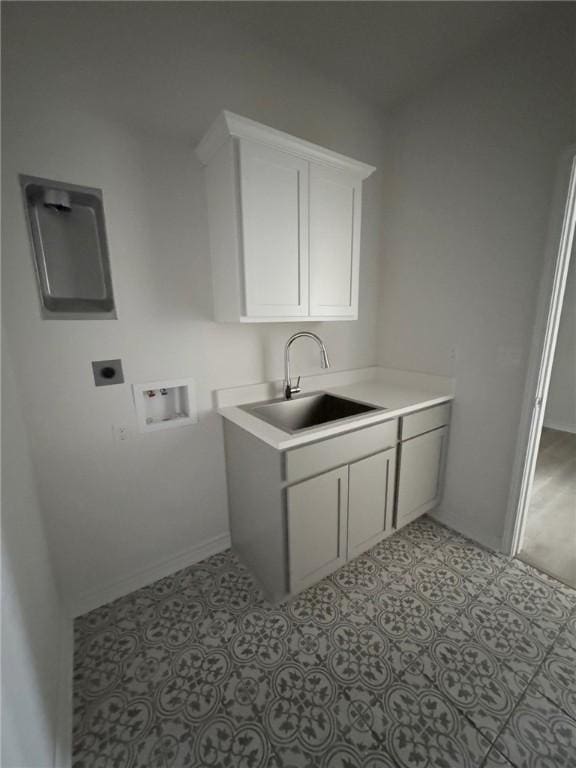 washroom featuring sink, hookup for a washing machine, hookup for an electric dryer, and light tile patterned floors