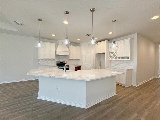 2550 Las Estrellas St, Corpus Christi, TX 78414 - kitchen with custom exhaust hood, baseboards, white cabinets, and recessed lighting