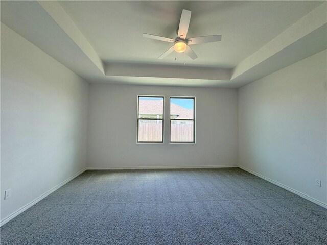2550 Las Estrellas St, Corpus Christi, TX 78414 - spare room with a tray ceiling, carpet floors, ceiling fan, and baseboards