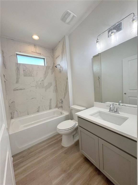 2550 Las Estrellas St, Corpus Christi, TX 78414 - full bathroom with wood finished floors, vanity, toilet, and shower / bath combination