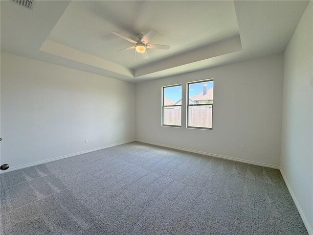 2550 Las Estrellas St, Corpus Christi, TX 78414 - spare room with a tray ceiling, a ceiling fan, carpet flooring, and baseboards