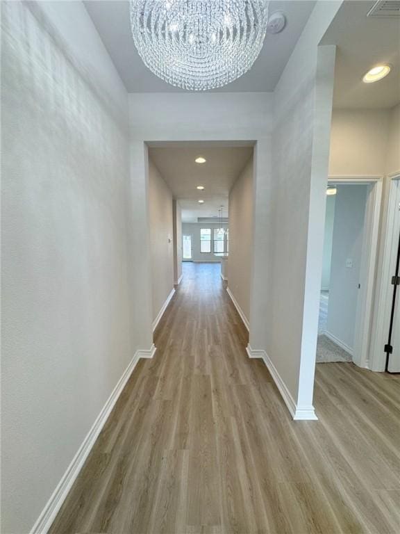 2550 Las Estrellas St, Corpus Christi, TX 78414 - hallway featuring a chandelier, wood finished floors, and baseboards