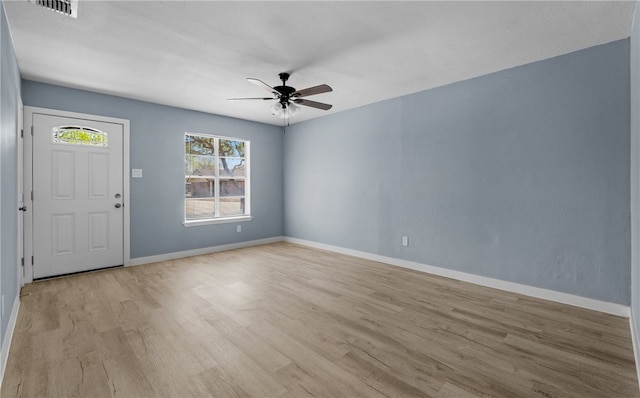 foyer entrance with visible vents, baseboards, light wood finished floors, and ceiling fan