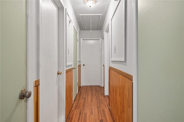 3718 Brushwood, Corpus Christi, TX 78415 - hall with attic access, light wood-style floors, a wainscoted wall, and wooden walls