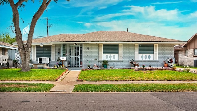 3718 Brushwood, Corpus Christi, TX 78415 - view of front of house featuring a porch, a front yard, and brick siding