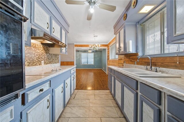 3718 Brushwood, Corpus Christi, TX 78415 - kitchen featuring a sink, light countertops, backsplash, and oven