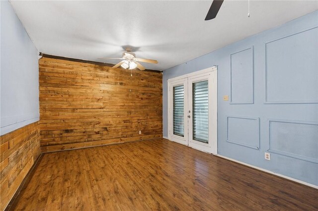 3718 Brushwood, Corpus Christi, TX 78415 - spare room with a ceiling fan, wood walls, and wood finished floors