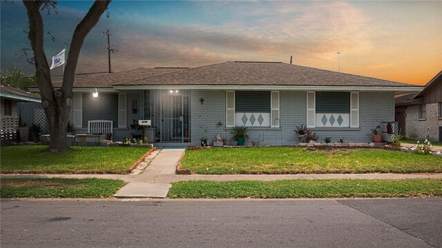 3718 Brushwood, Corpus Christi, TX 78415 - bungalow-style house with a front lawn, brick siding, a porch, and roof with shingles