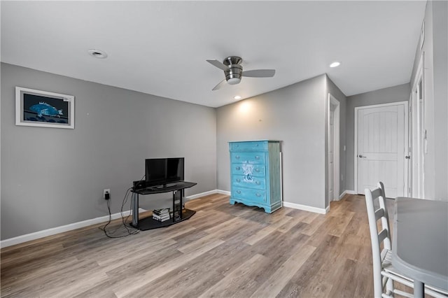 interior space with a ceiling fan, recessed lighting, light wood-style flooring, and baseboards