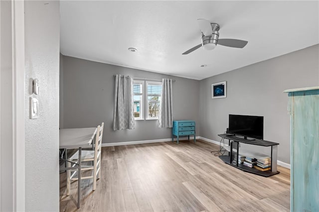 office area featuring wood finished floors, a ceiling fan, and baseboards