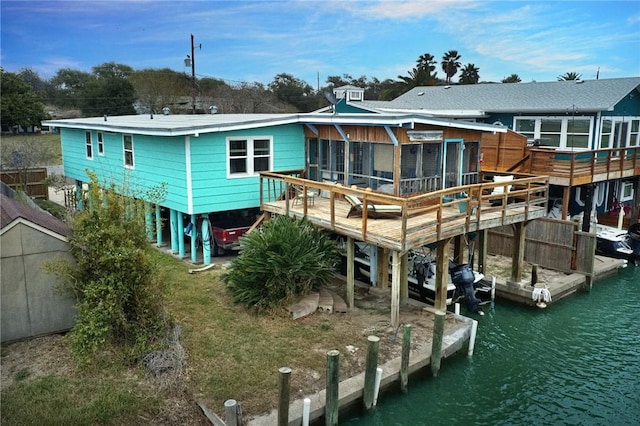 rear view of property with a water view