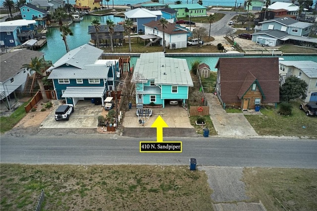 birds eye view of property with a water view and a residential view