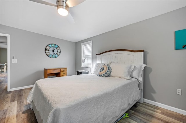 bedroom featuring wood finished floors, a ceiling fan, and baseboards