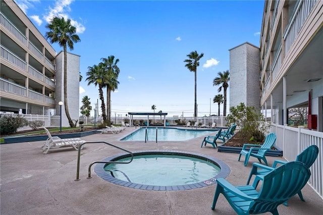 view of swimming pool with a community hot tub and a patio