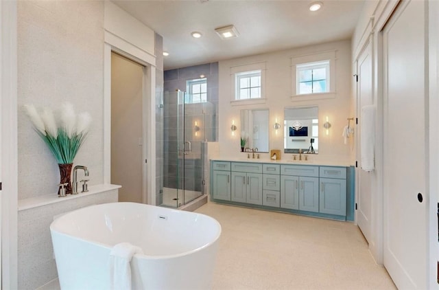 bathroom with vanity and separate shower and tub