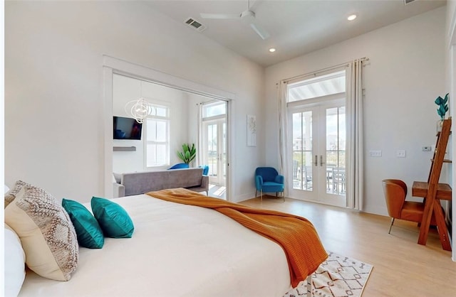 bedroom with ceiling fan, light hardwood / wood-style floors, access to exterior, and french doors