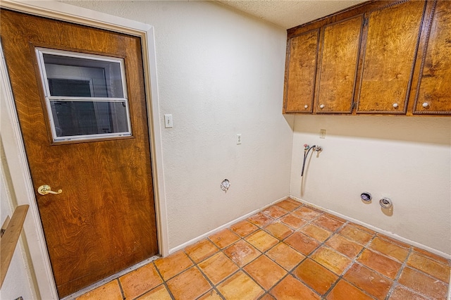 4513 Greensboro Dr, Corpus Christi, TX 78413 - laundry room featuring cabinet space, light tile patterned flooring, and a textured ceiling