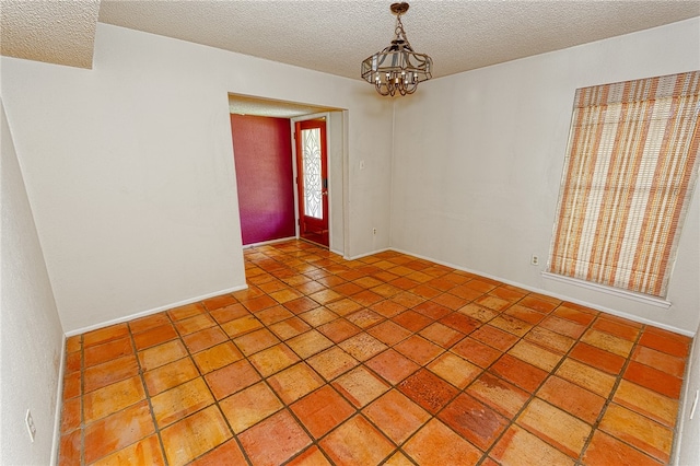 4513 Greensboro Dr, Corpus Christi, TX 78413 - empty room with a textured ceiling, a chandelier, and light tile patterned floors