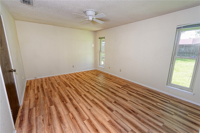 4513 Greensboro Dr, Corpus Christi, TX 78413 - empty room featuring light wood finished floors, a textured ceiling, and a ceiling fan