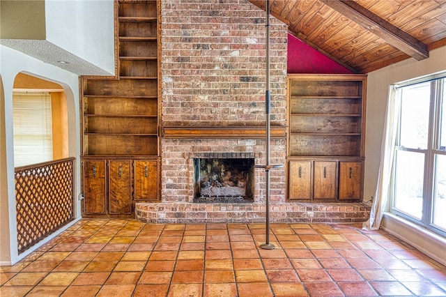 4513 Greensboro Dr, Corpus Christi, TX 78413 - unfurnished living room featuring built in features, wooden ceiling, a brick fireplace, and arched walkways