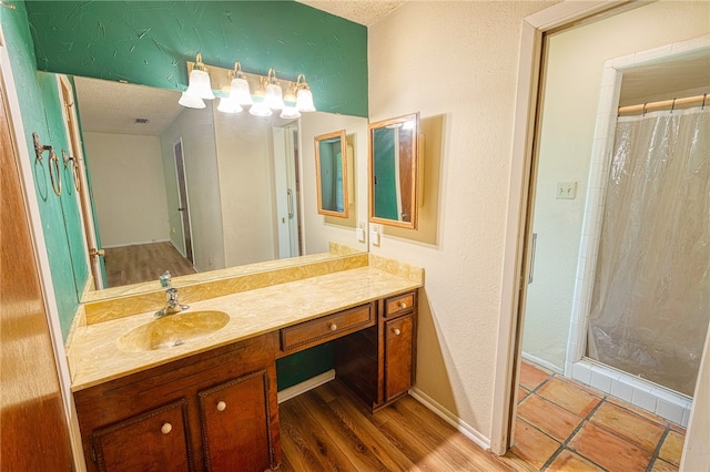 4513 Greensboro Dr, Corpus Christi, TX 78413 - full bathroom with vanity, wood finished floors, a shower with curtain, and a textured wall