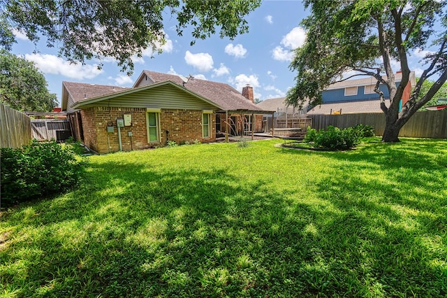 4513 Greensboro Dr, Corpus Christi, TX 78413 - back of house featuring a fenced backyard, brick siding, and a chimney