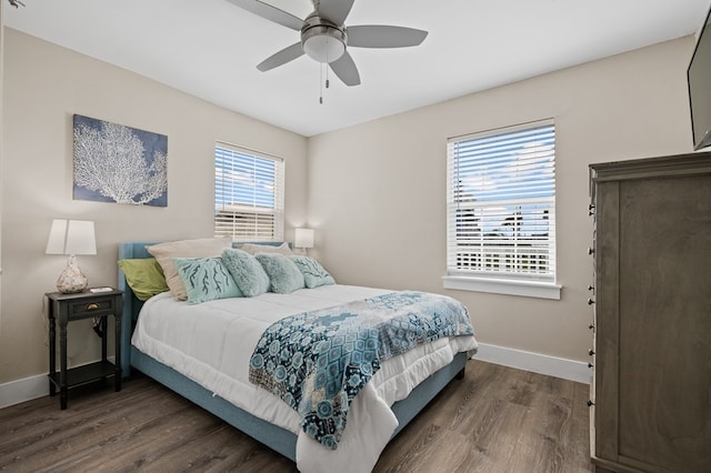 bedroom with ceiling fan and dark wood-type flooring