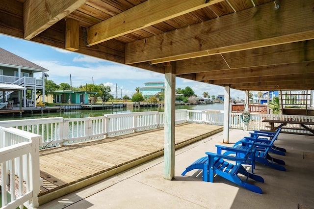 dock area featuring a deck with water view