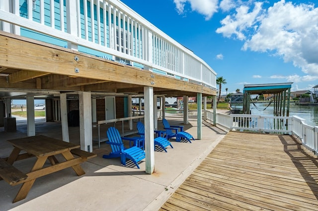 view of dock with a deck with water view