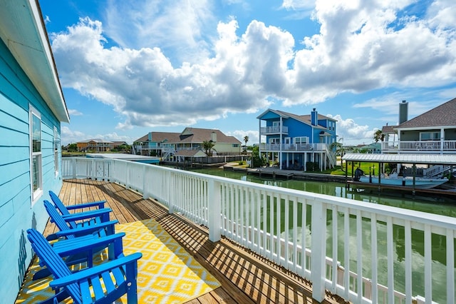 balcony featuring a deck with water view