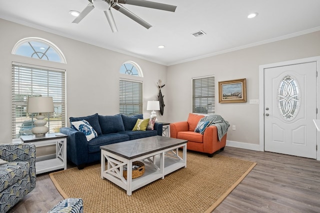 living room with ceiling fan, hardwood / wood-style floors, and ornamental molding