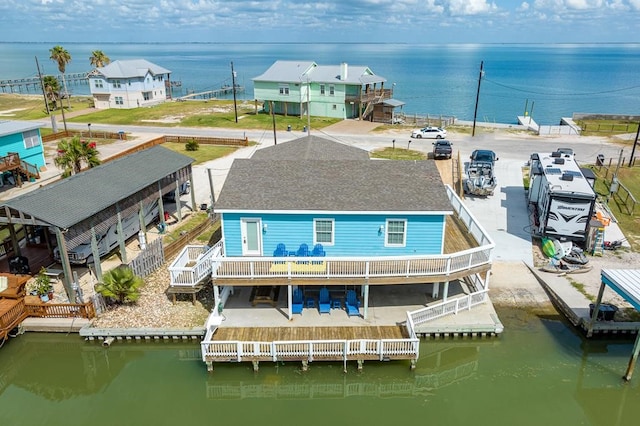 back of property featuring a deck with water view