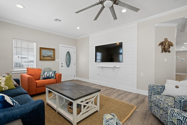 living room featuring crown molding, ceiling fan, and hardwood / wood-style flooring