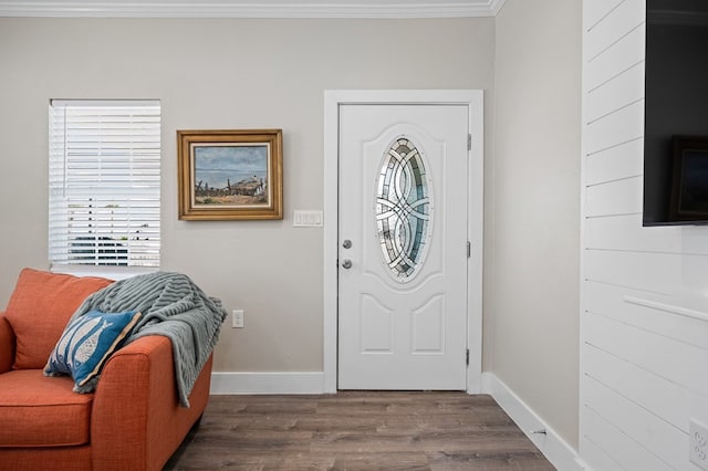 foyer with wood-type flooring and crown molding