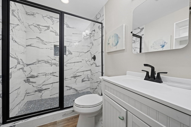 bathroom featuring wood-type flooring, vanity, toilet, and walk in shower