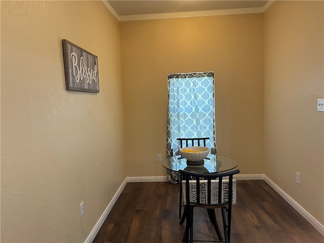 dining space with dark wood-type flooring and crown molding