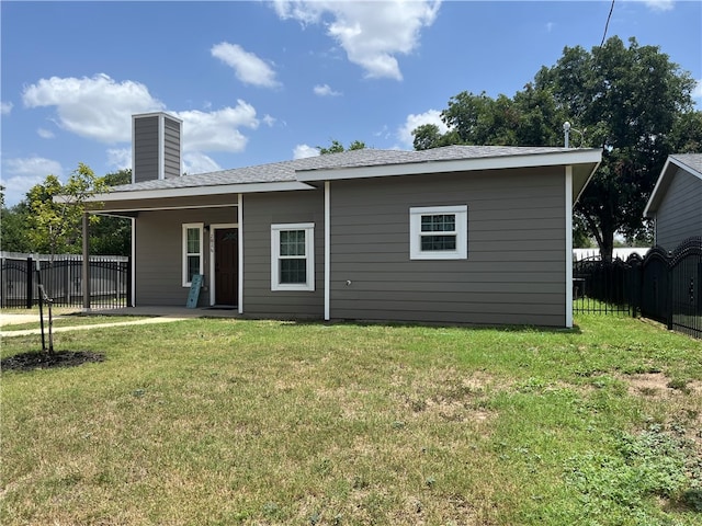 back of house with a lawn