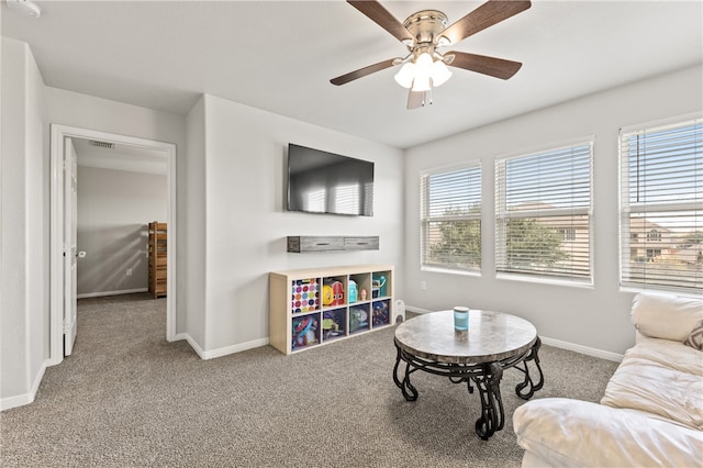 carpeted living room with ceiling fan