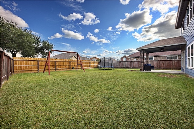 view of yard featuring a trampoline and a patio area