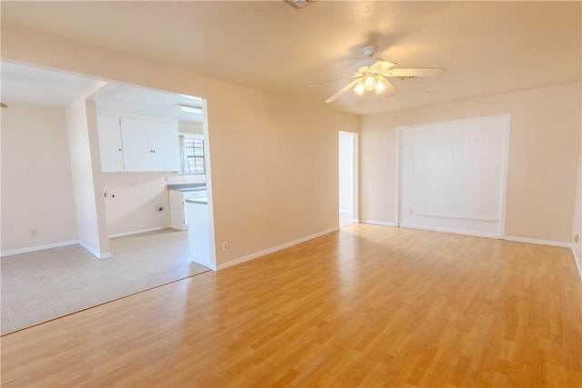 spare room featuring ceiling fan and light wood-type flooring