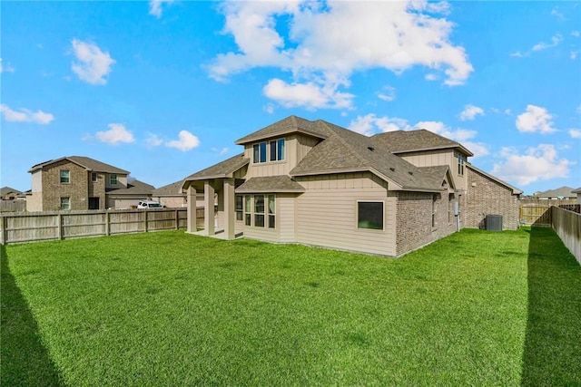 back of property with a lawn and cooling unit