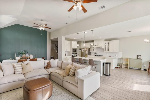 living room featuring ceiling fan and light wood-type flooring