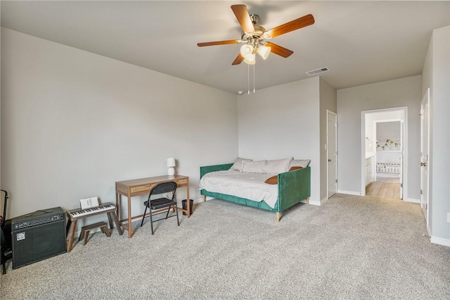 carpeted bedroom featuring ceiling fan and ensuite bathroom