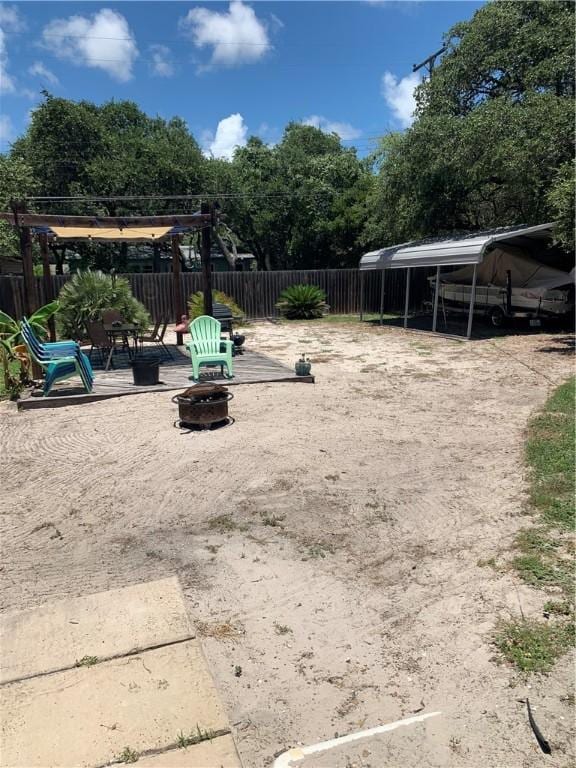 view of jungle gym featuring an outdoor fire pit and view of scattered trees
