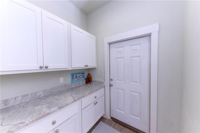 101 Boardwalk Ave, Rockport, TX 78382 - interior space with light stone countertops, white cabinetry, and dark wood finished floors