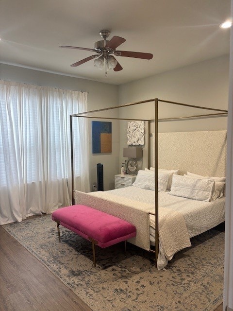 bedroom with ceiling fan and wood finished floors