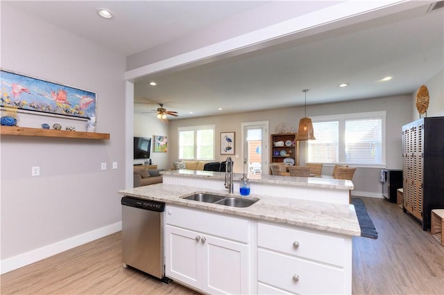 101 Boardwalk Ave, Rockport, TX 78382 - kitchen featuring white cabinetry, a kitchen island with sink, stainless steel dishwasher, light wood finished floors, and a sink