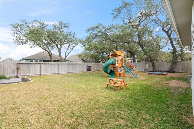 view of yard with a fenced backyard and a playground