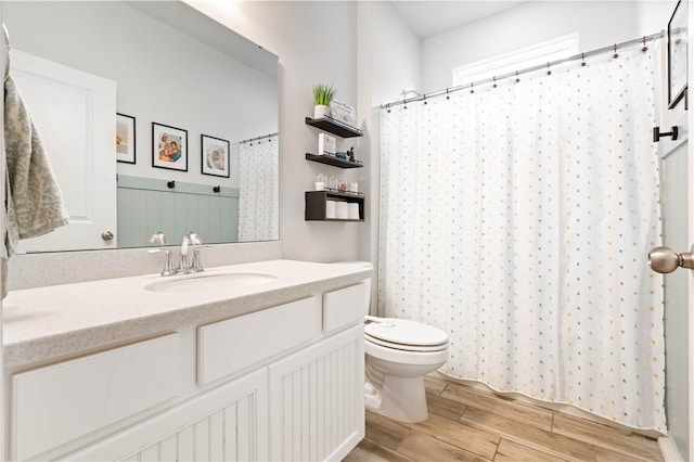 bathroom featuring a shower with curtain, vanity, toilet, and wood tiled floor